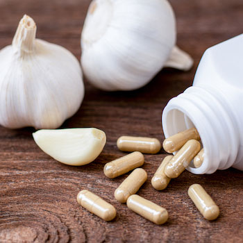 Bulbs of garlic and garlic supplement capsules
